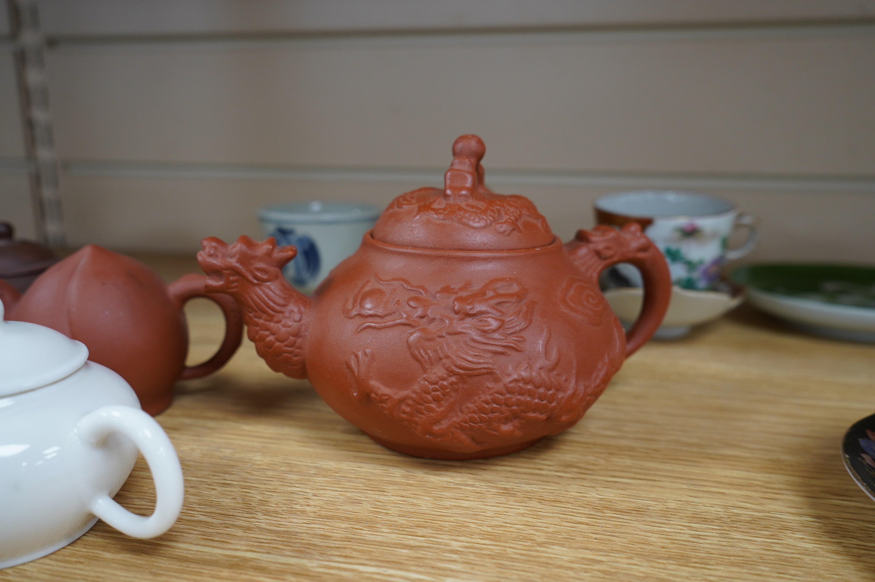 A group of Chinese and Japanese ceramics to include Yixing teapots, porcelain cups and saucers, a blue and white vase and a tiger talisman. Condition - mostly good